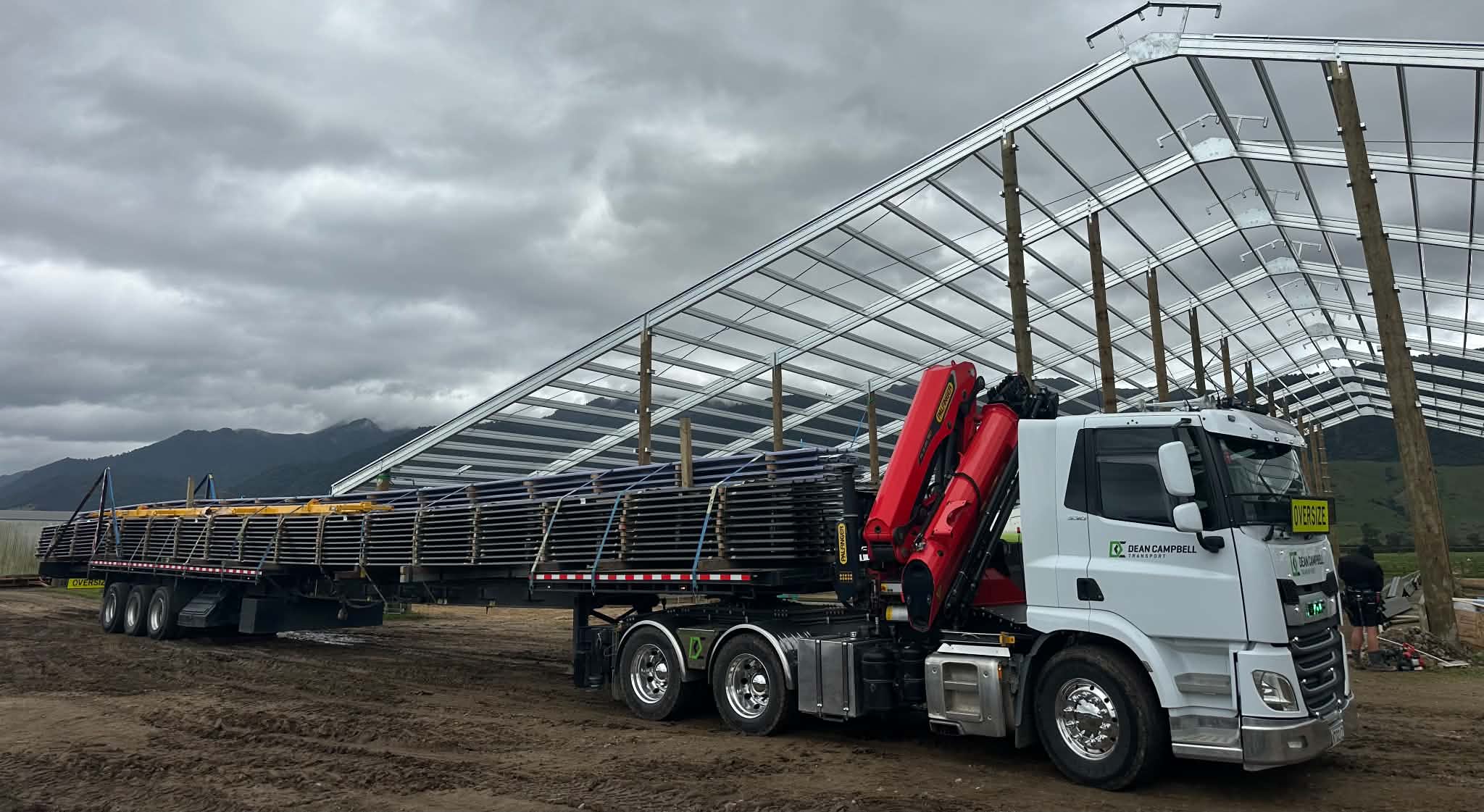 Oversize purlin load alongside a shed build