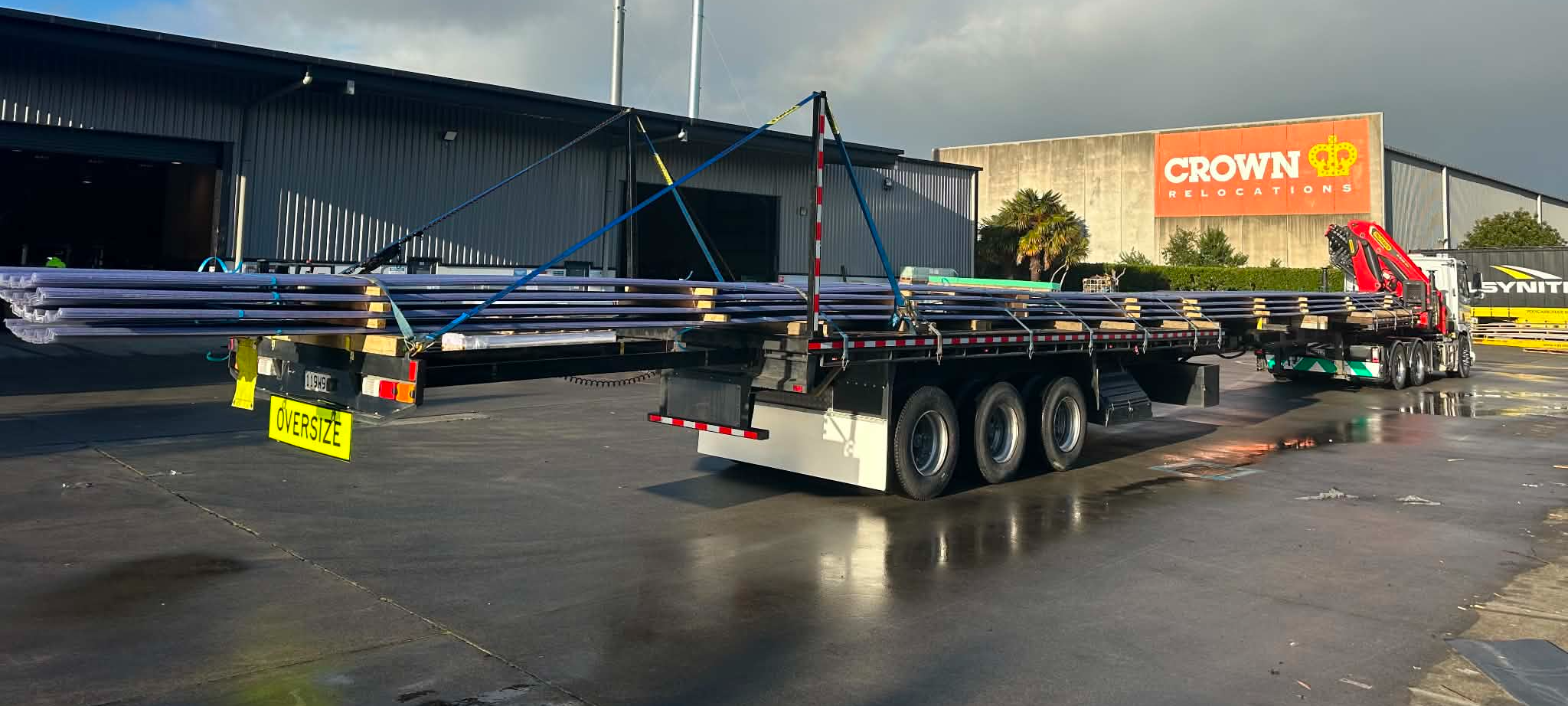 Over-length steel load on the trailer, oversize signed