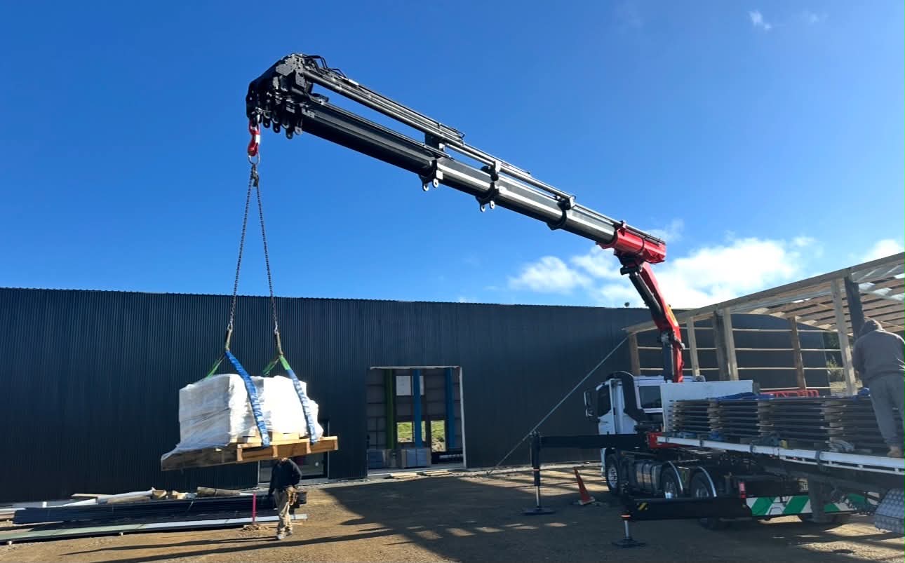 HIAB crane placing a palletised load on site