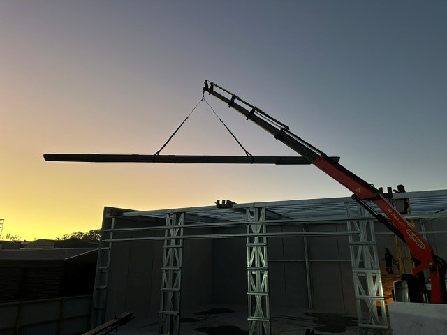 HIAB crane lift at sunset